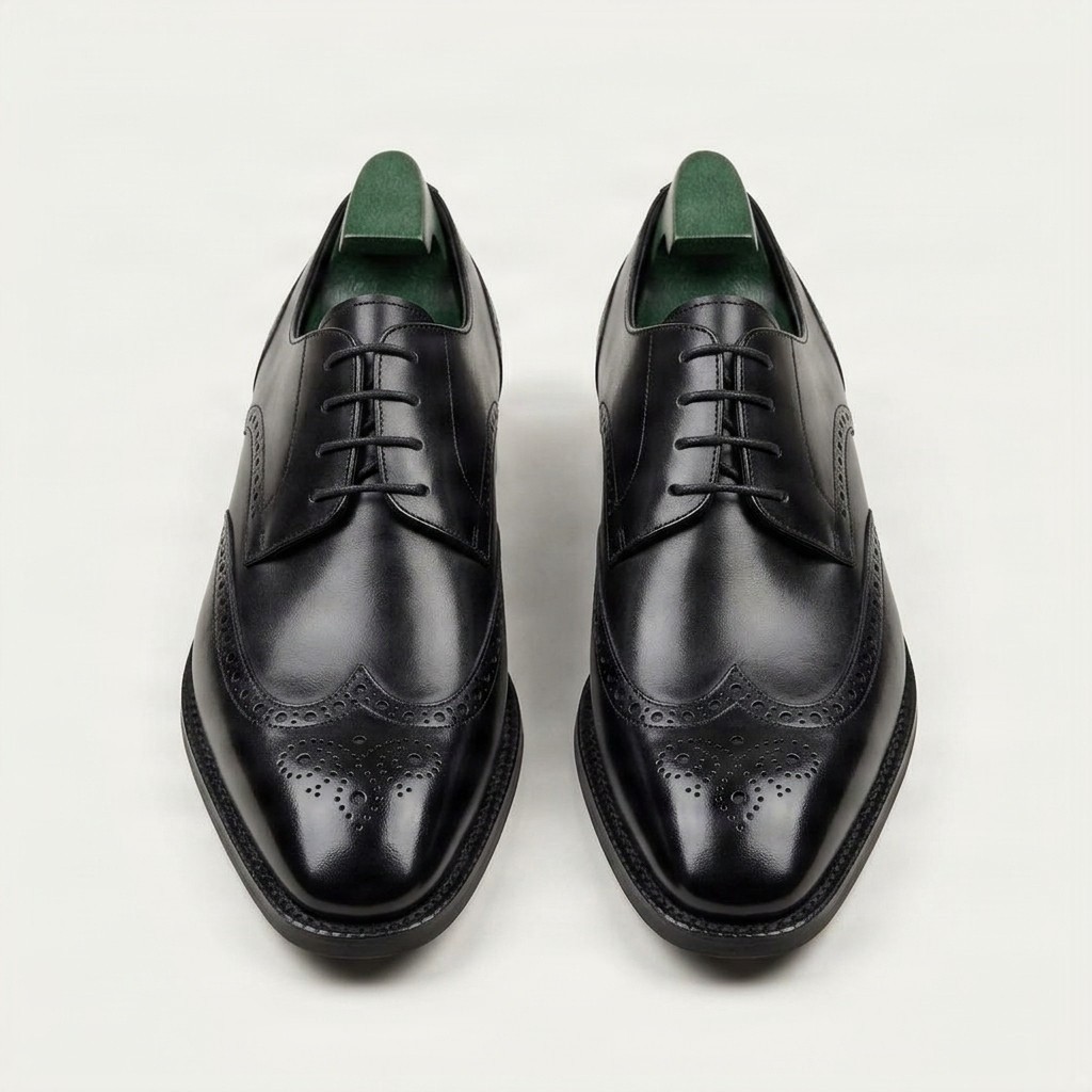 Black leather wingtip brogues for men