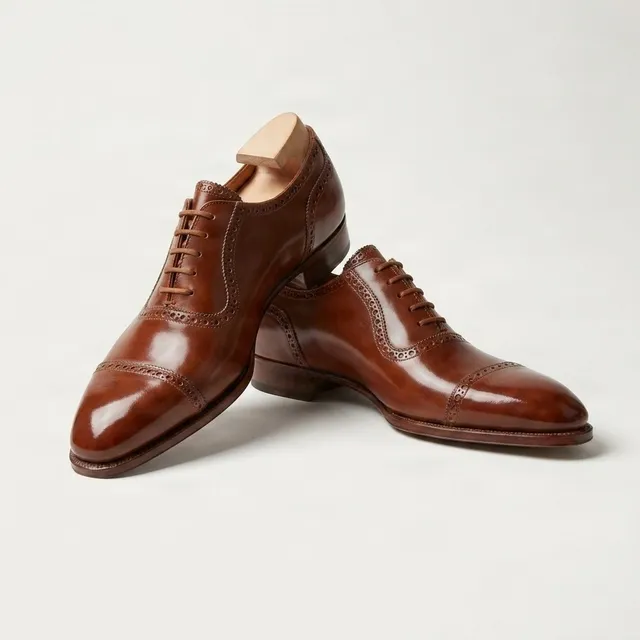 Brown leather cap toe brogues punched