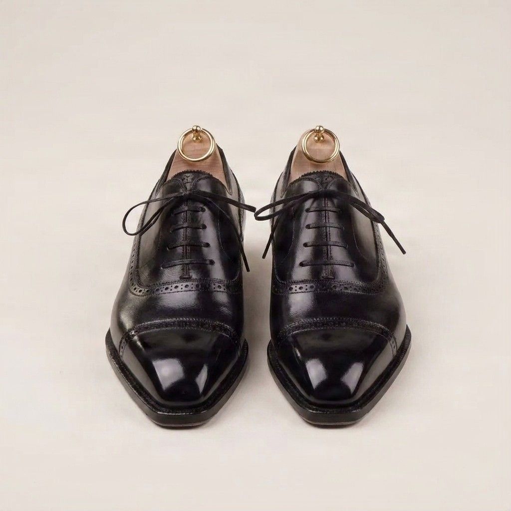 Black leather cap toe brogues