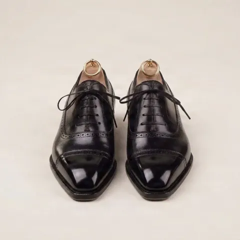 Black leather cap toe brogues