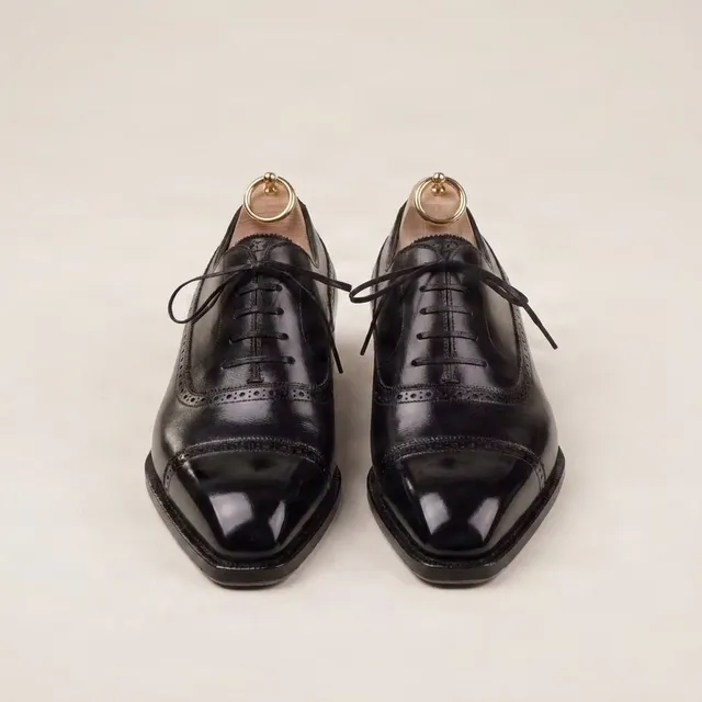 Black leather cap toe brogues