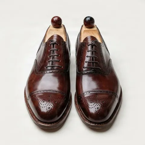 Brown leather cap toe brogues medallion