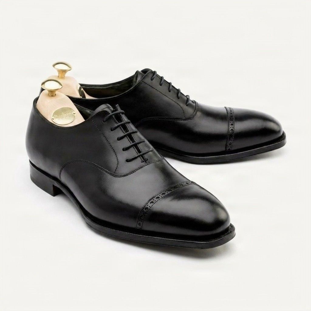 Black leather cap toe brogues