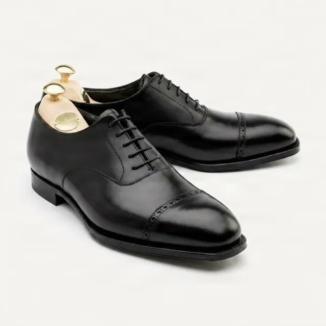 Black leather cap toe brogues