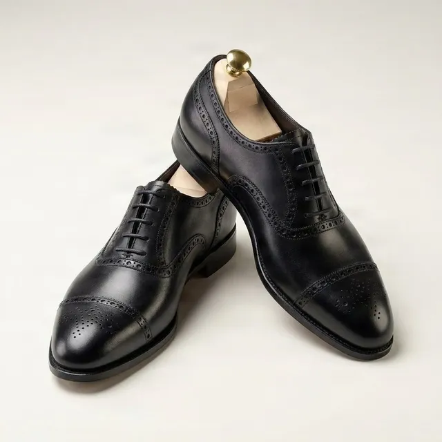 Black leather cap toe brogues medallion punched