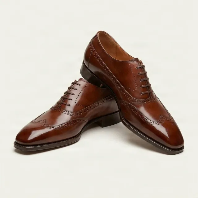Cognac leather wingtip brogues medallion