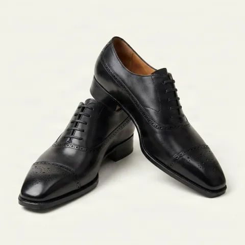 Black leather cap toe brogues medallion