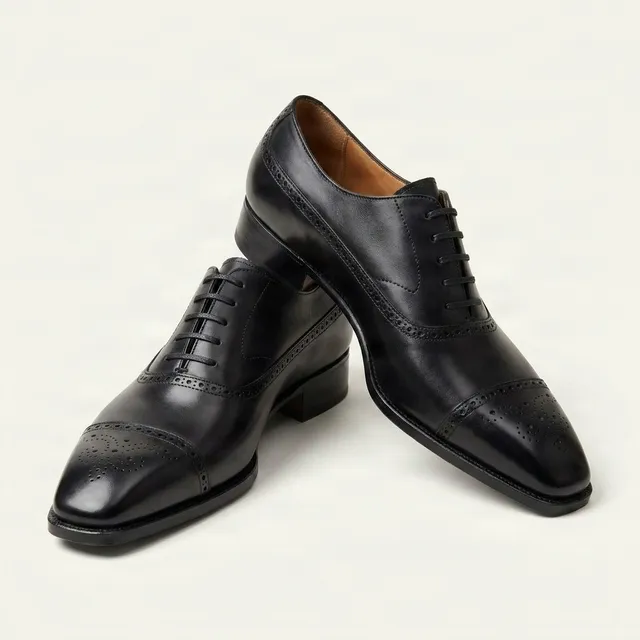 Black leather cap toe brogues medallion
