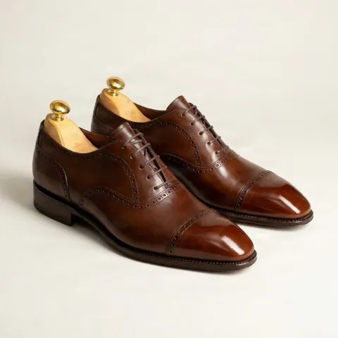 Brown leather cap toe brogues heel