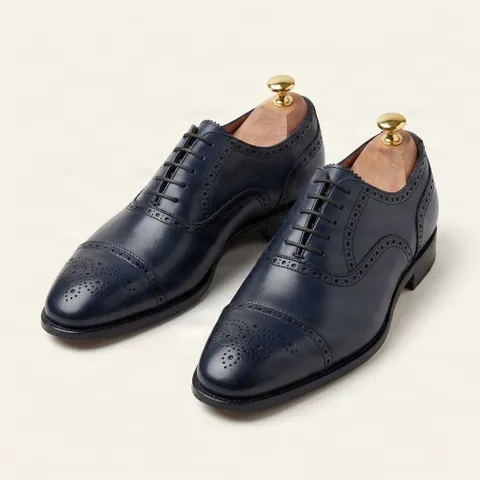 Navy leather cap toe brogues punched