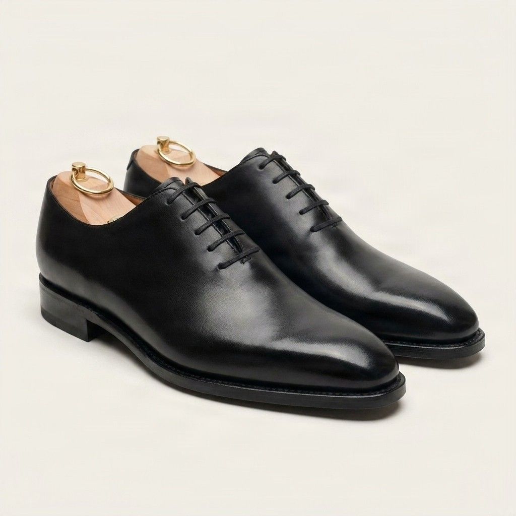 Black leather wholecut oxfords